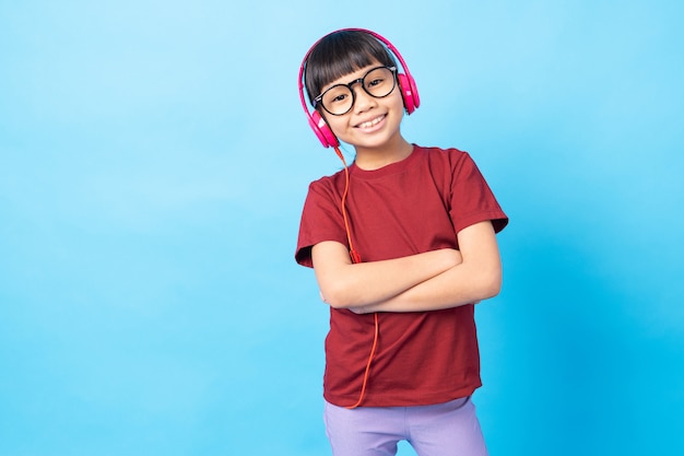 Thai asia girl kid listening music, wearing pink earphone