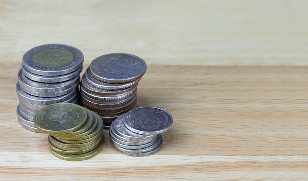 Thai baht coins on wood grain background detail object blur