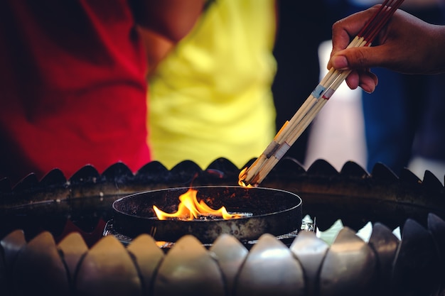 Thai Buddhists use incense to worship Buddha