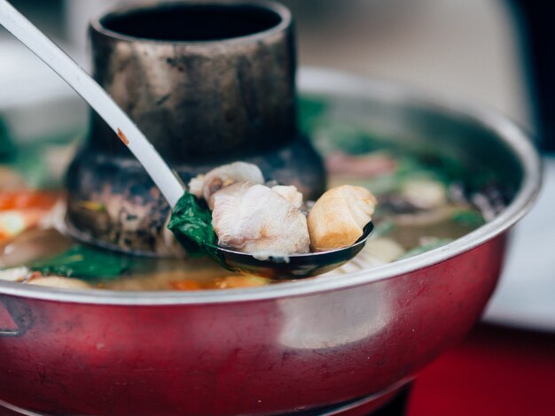 Thai clear soup spicy tom yum seafood in hot pot.