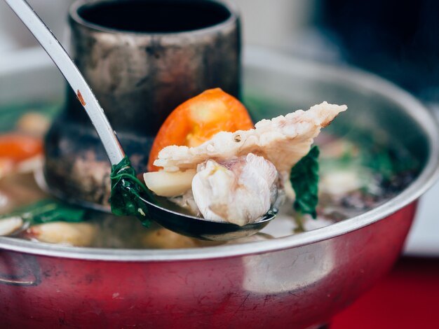 Thai clear soup spicy tom yum seafood in hot pot.