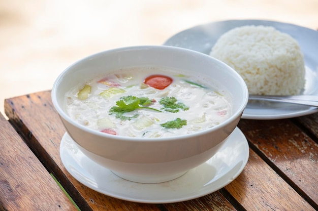 Thai coconut cream soup in bowl close up