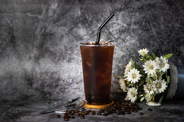 背の高いプラスチックカップに入ったタイのコーヒーガラスの冷たいものの横に蒸気があります