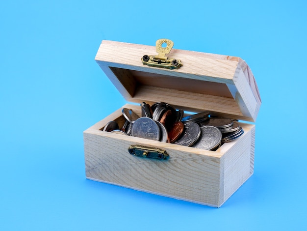 Thai coin in the wood chest on blue background