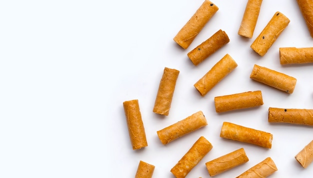 Thai crispy coconut rolls on white background.