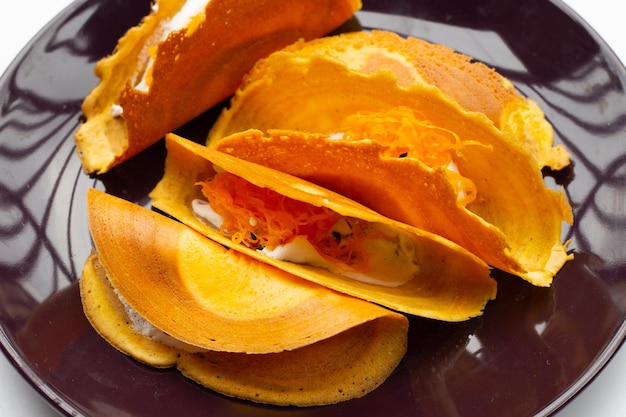 Thai crispy pancakes in plate on white background