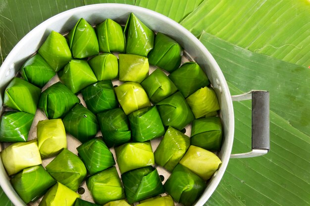 Thai dessert made of rice flour and coconut with sugar, Banana leaf wrap (raw)