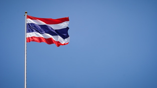 Thai flag on a flying pole flickering on the background of the sky