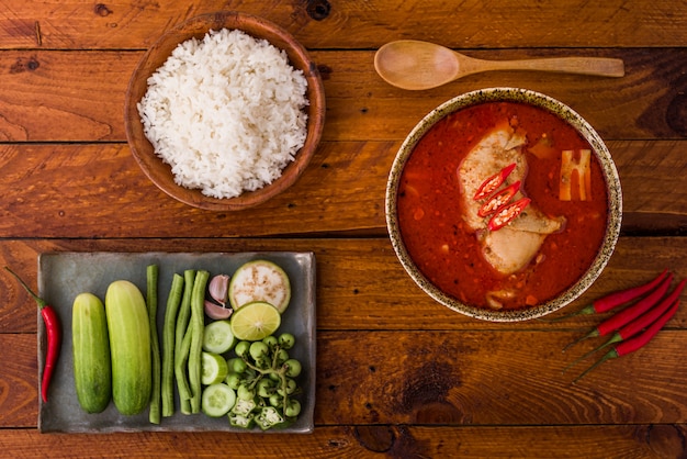 Thai food, chicken mussaman curry in a bowl and rice on wood 