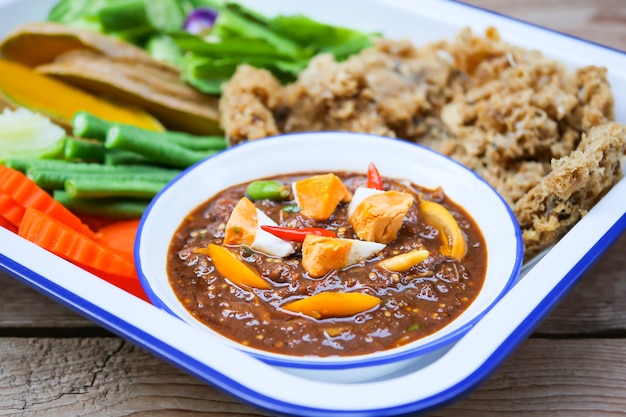 Thai food name Naam Phrik Lohng Reuua (Boat Embarking Chili Relish) is relish of fermented shrimp paste sauce with  crispy deep fried fluffy fish, salted eggs and vegetables