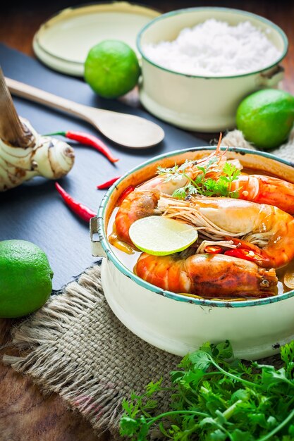 Thai food, River prawn spicy soup or tom yum goong on wooden table 