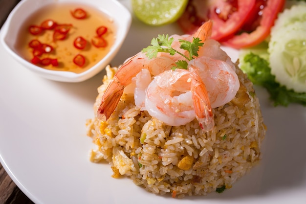 Thai fried rice with prawns in a white plate.