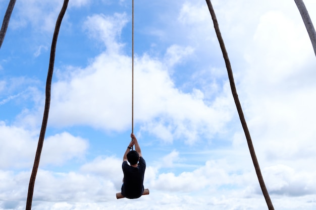 Photo thai male was playing wooden the swings at khao kho