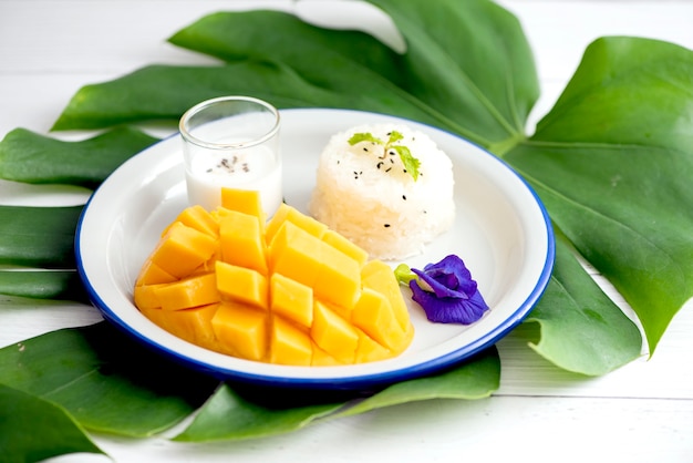 Mango tailandese con riso appiccicoso sul piatto bianco