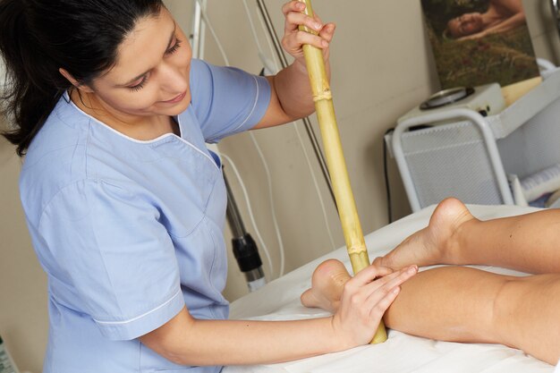 Thai massage with bamboo stick