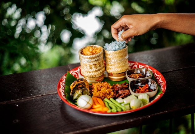 Thai menu set.hand show sticky rice and Grilled pork pieces.