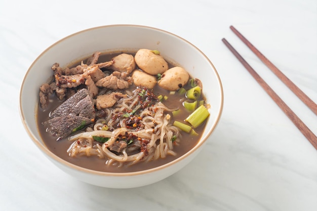 Thai noodle with pork stewed pork meatball and pork liver in blood soup