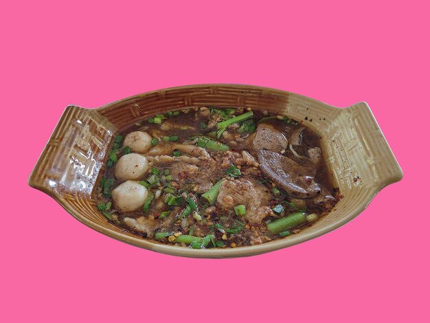 Thai noodle with stewed pork, meatball and blood soup in a boat shape bowl