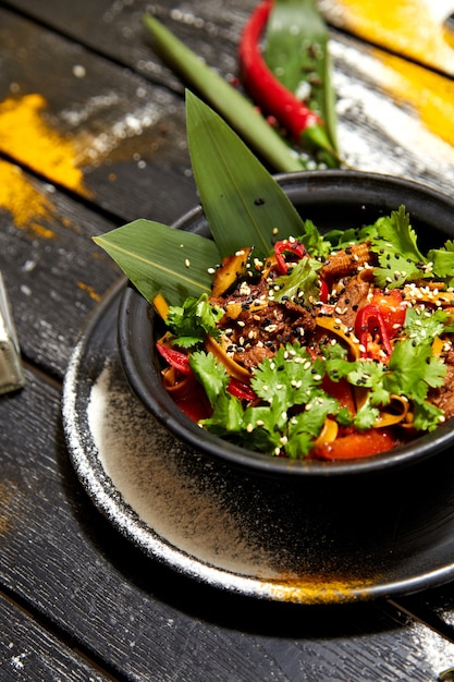 Thai noodles with beef and herbs in a bowl