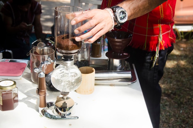 Thai people use Syphon Coffee Maker made hot coffee for show and sale for people at shop in organic market on January 29 2017 in Nakhon Ratchasima Thailand