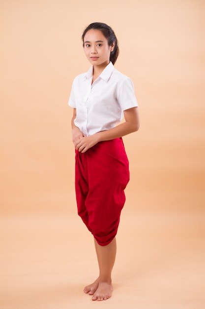 Thai performance art, woman dancer student dancing in traditional red loincloth