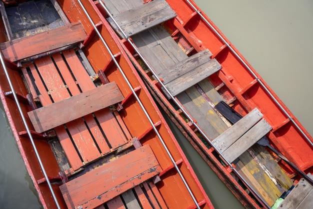 Thai red wooden boats in the river. Top view.