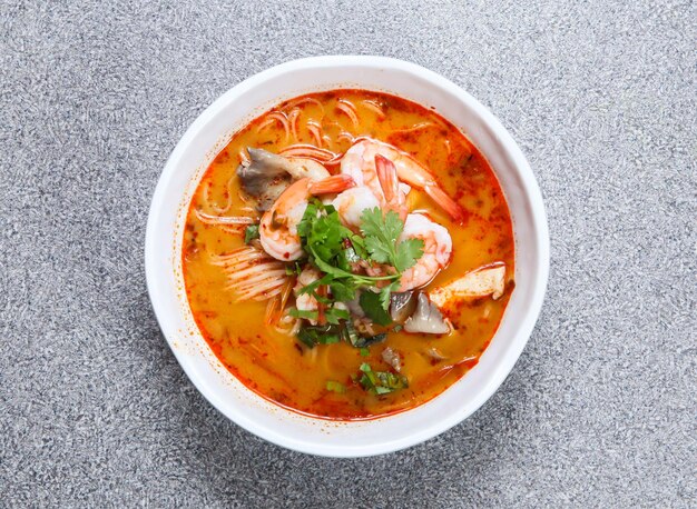 Thai rice noodle in tom yum kung soup served in soup isolated on grey background top view of hong kong food