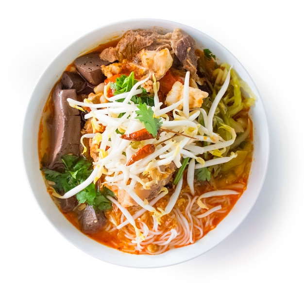 Thai rice vermicelli with spicy pork sauce. Northern Thai food made of rice vermicelli or rice noodle in spicy sauce with pork or meat top view isolated