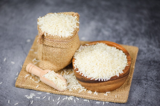 Thai rice white on bowl and the sack / raw jasmine rice grain agricultural products for food in Asian