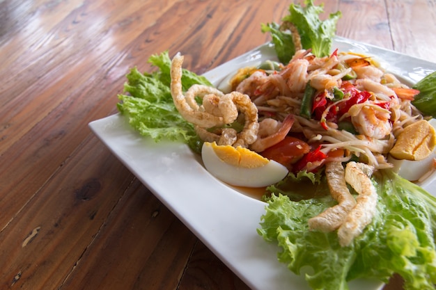 Thai's spicy Papaya salad healthy food on wood table