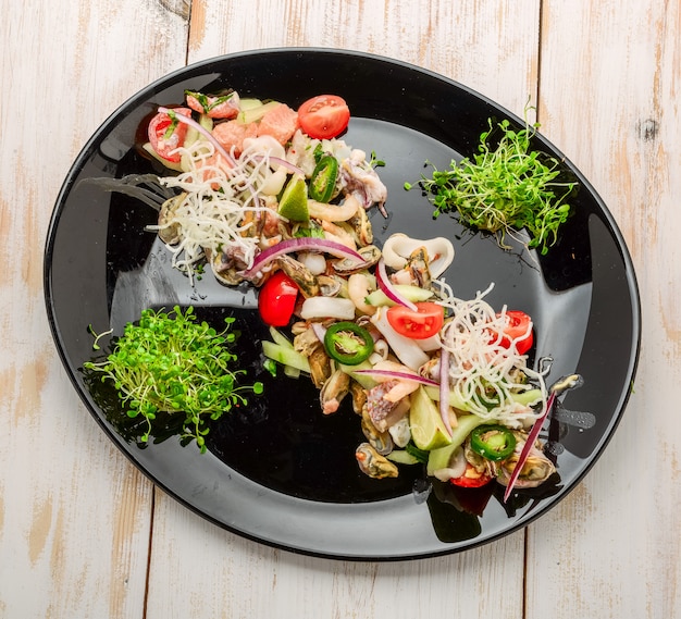 Thai spicy and sour seafood salad on a wooden table