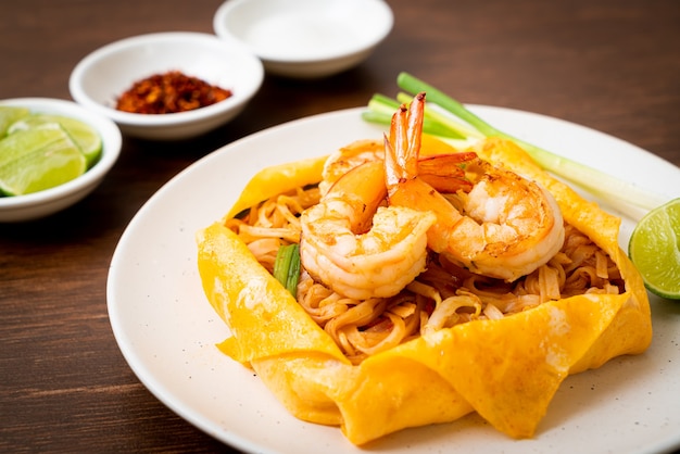 Thai stir fried noodles with shrimps and egg wrap (Pad Thai) - Thai food style