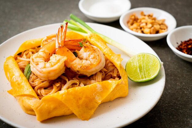 Thai stir fried noodles with shrimps and egg wrap (Pad Thai) - Thai food style