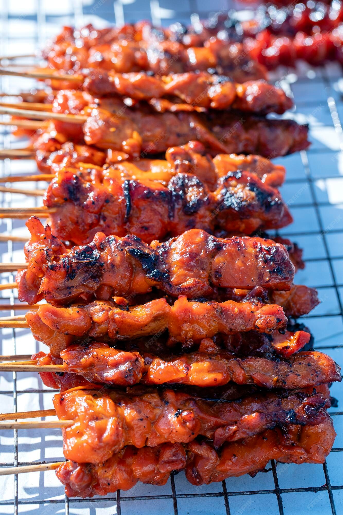 Premium Photo  Closeup of grilled skewered milk pork on stick thai street  food market