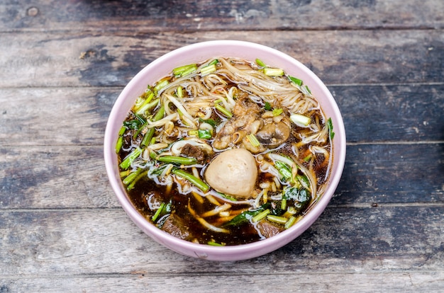 Thai style beef noodle on wooden table