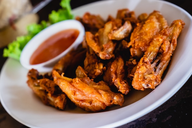 Thai style homemade deep fried chicken wings on white plate