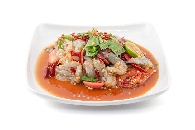 Thai Style spicy seafood salad with shrimps isolated on white