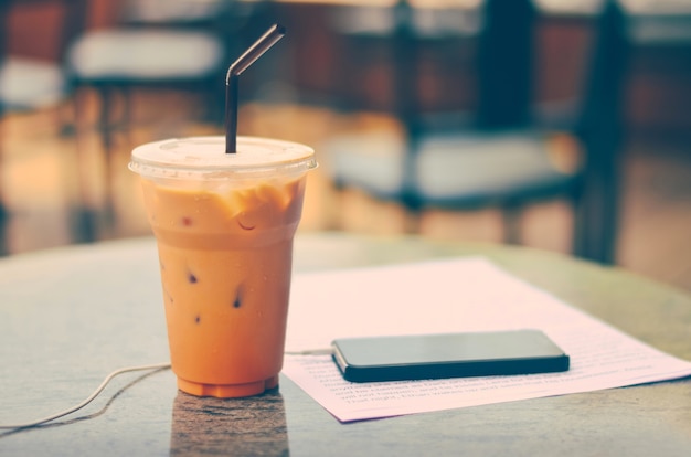 Thai tea cup in coffee shop with vintage filter