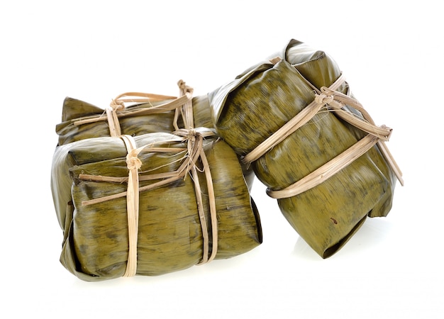 Thai traditional sticky rice dessert in banana leaf packaging.