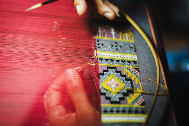 Thai woman making silk thread. A traditional way of hand made silk production.