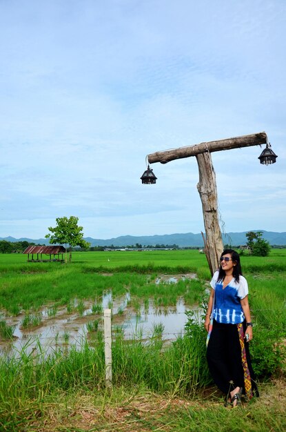 Thai woman portrait with pole lamp thai style at rice field in Phrae Thailand