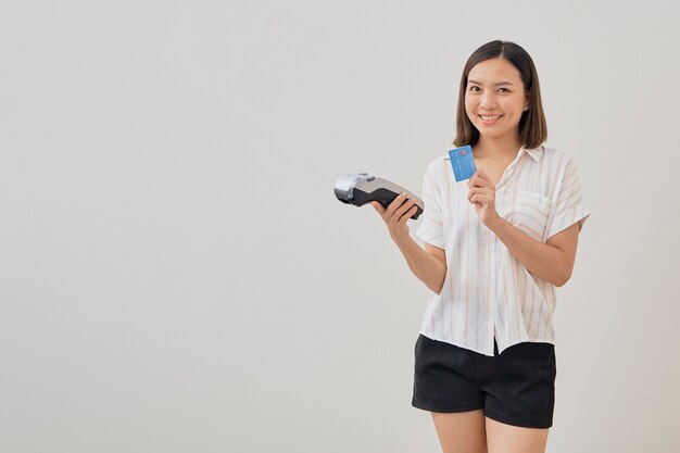 Thai woman presenting credit card for making payment