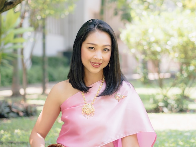 Thai woman in traditional Thai costume of ordinary Thai ancient lady in the garden.