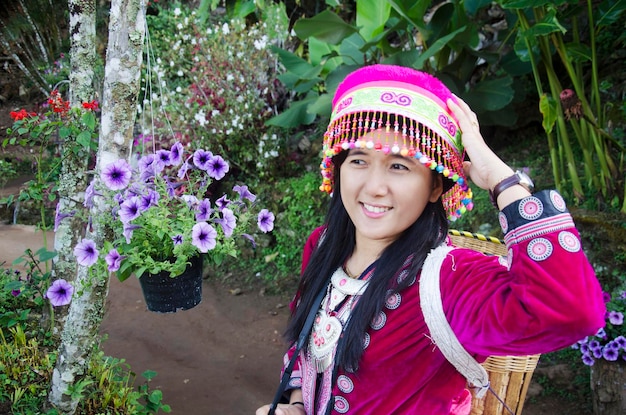 Thai women wearing costume traditional of ethnic hmong for take photo in garden with flower and visit Doi Pui Tribal Village and National Park at morning time in Chiang Mai Thailand