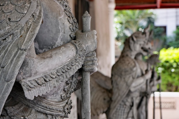 Thailand, Bangkok, Amarintharam Worawihan Temple, sacred statues at the entrance