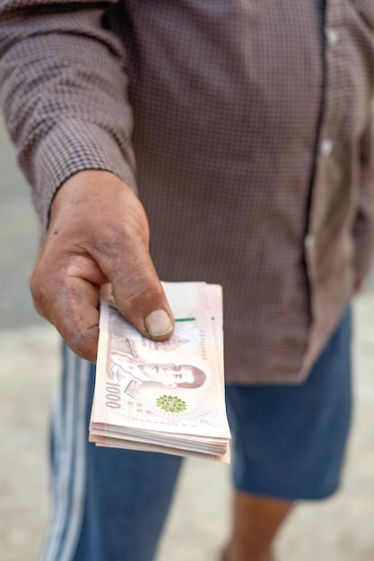 Thailand banknote money holded by farmer hand