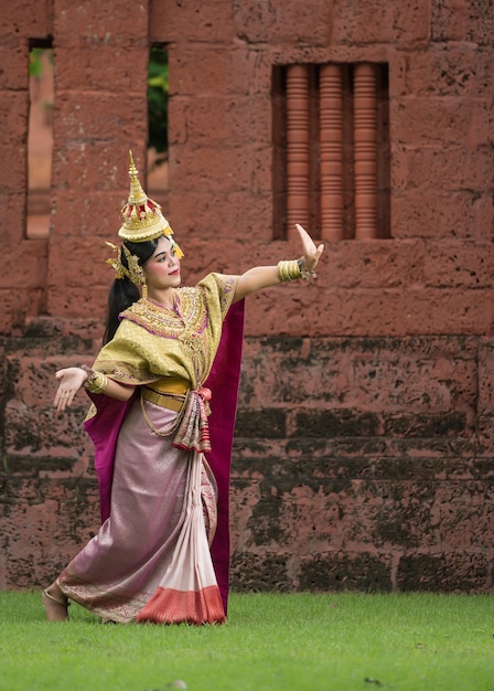 Thailand Dancing in masked khon Benjakai with ancient temple