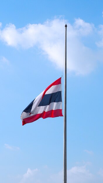 Thailand flag and clear blue sky and white clouds.