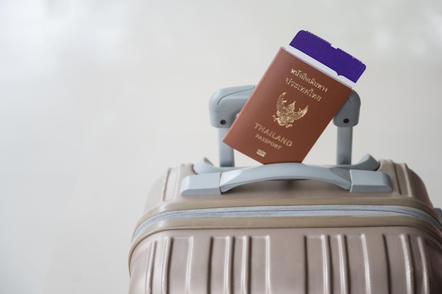 Thailand Passport and Suitcase on the White Background Travel Concept