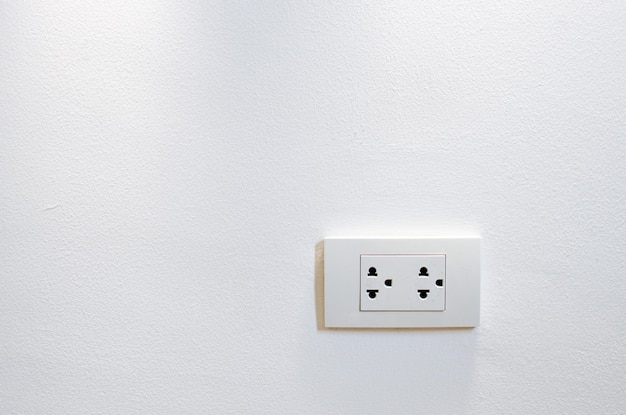 Thailand power socket electrical plug isolated on the white wall background